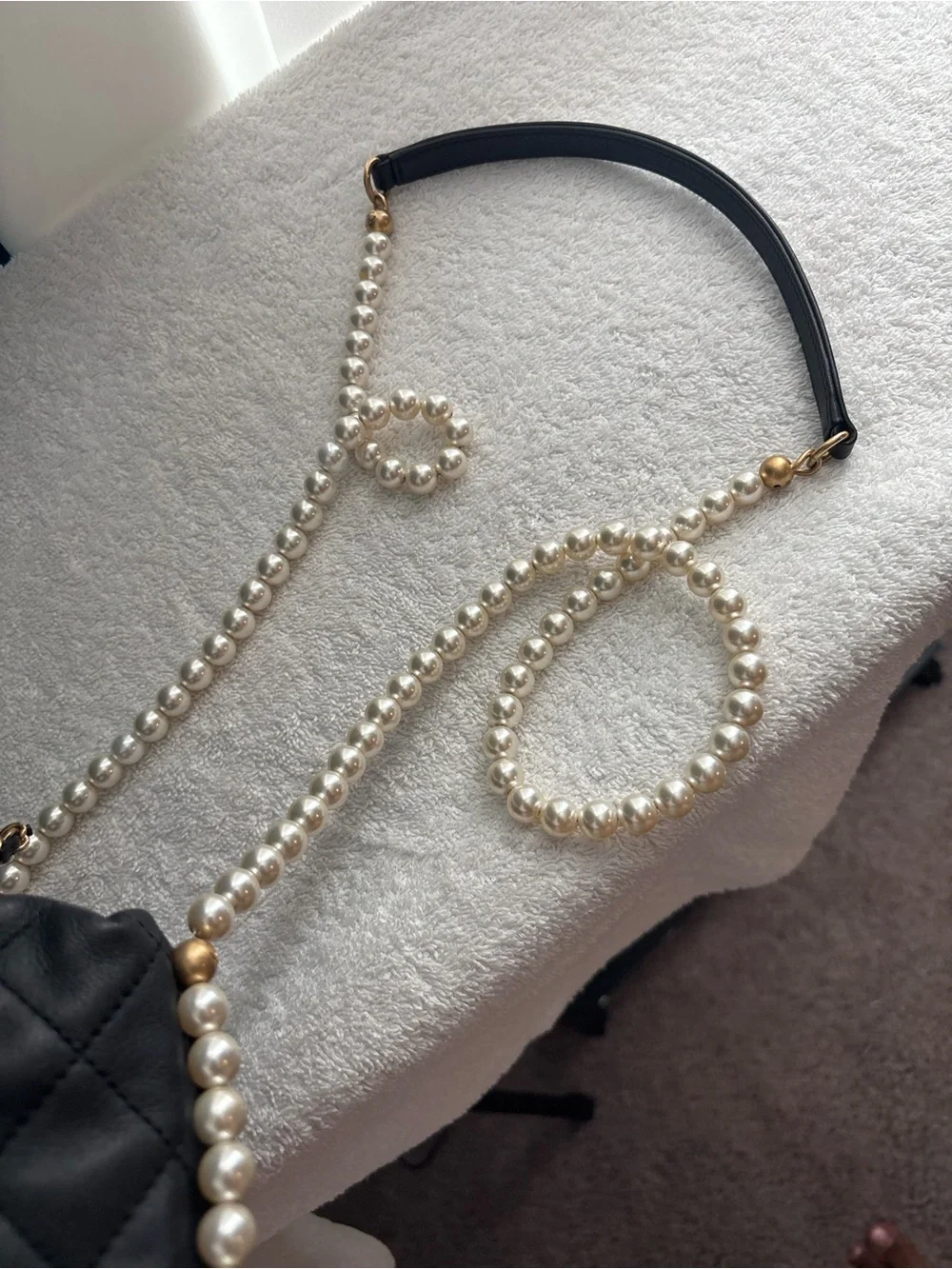 CHANEL Pearl Drawstring Bucket Bag in Black Quilted Lambskin with Pearl Strap